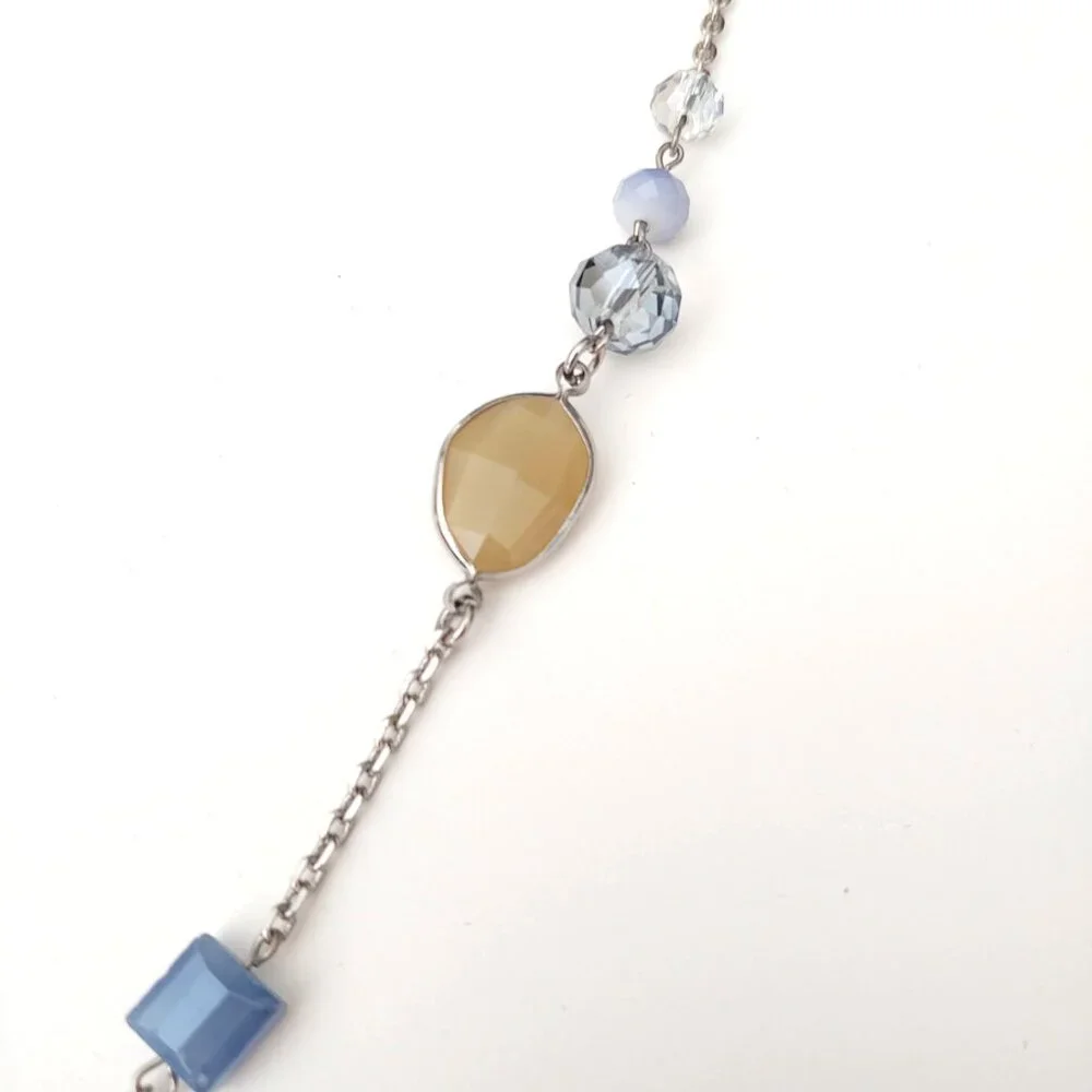 Long silver necklace with blue and yellow glass beads